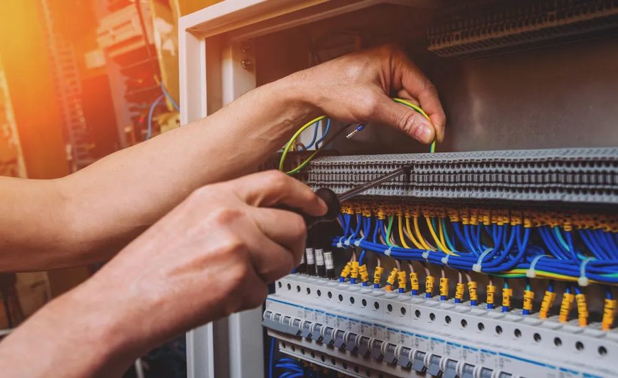 Electrician testing a DB box and breaker panel in a Karachi home